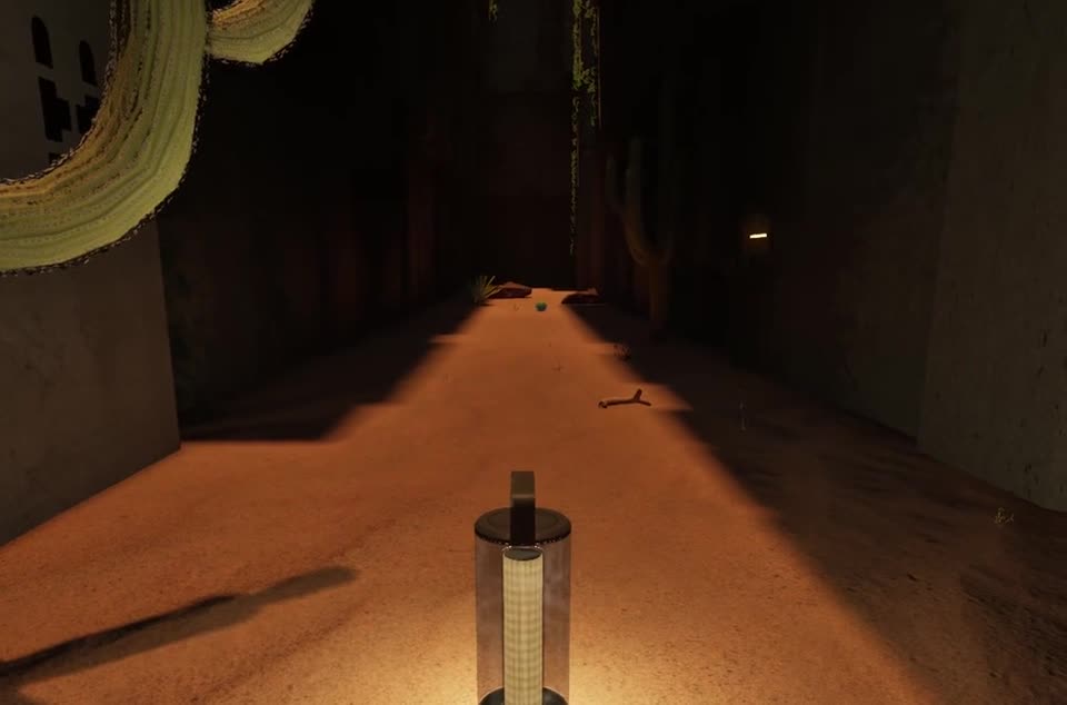 A lantern left on the sand in a dark corridor